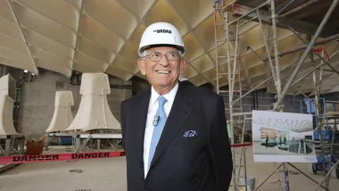 Eli Broad wearing a hard hat standing at the construction site of The Broad museum