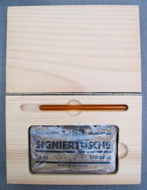 Joseph Beuys - Wirtschaftswert Signiertusche, 1983, block of signature ink in wrapper, with handwritten addition, and glass pen; in wooden box