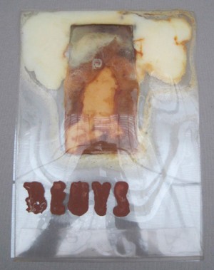 Joseph Beuys - aus Künstlerpost, 1969, plastic envelope with margarine and white chocolate, stamped; envelope stamped with oil paint (Browncross)