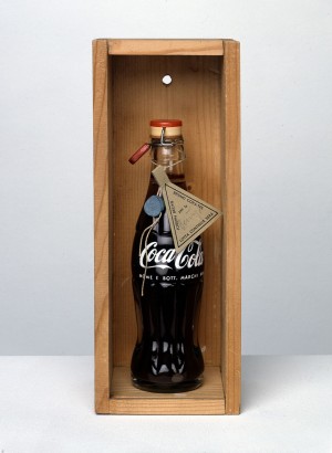 Joseph Beuys - Bruno Corà-Tee, 1975, Coca-Cola bottle containing herb tea, with lead seal and label; in glass-fronted wooden box
