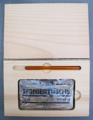 Joseph Beuys - Wirtschaftswert Signiertusche (Economic Value Signature Ink), 1983, block of signature ink in wrapper, with handwritten addition, and glass pen; in wooden box