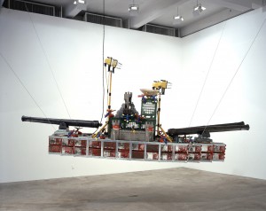 Chris Burden - Bateau de Guerre, 2001, 172 metal gasoline cans, 3 cannons on wooden swivels, 8 plastic torpedoes, 18 plastic submarine bombers, 4 plastic rescue submarines, 2 metal lamps, 5 plastic castle towers (2 on each side, 1 on top) with attached weaponry, 1 straw Chinese radar hat, 4 pl