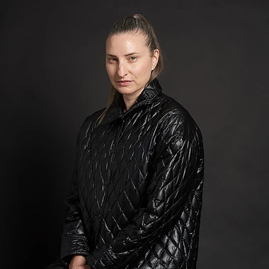 MPA the artist, wearing a black puffy jacket and a slicked back ponytail