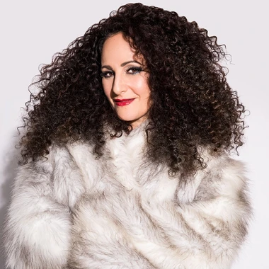Nadya Ginsburg in a fur coat against a white background