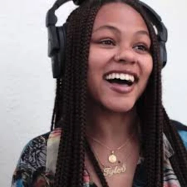DJ Tyler Boogie Boudreaux wearing headphones, smiling