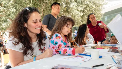 family making art at a table