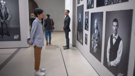 Photo of visitor looking at Shirin Neshat's work.