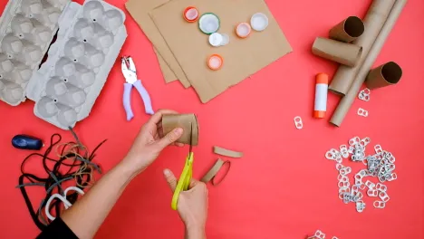 still of woman's hands making an art activity from the El Anatsui-inspired family art workshop