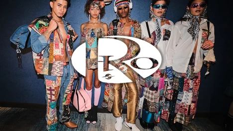 A group of five models modeling Rio World clothing behind a Rio white logo