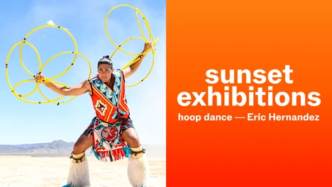 man in desert hoop dancing