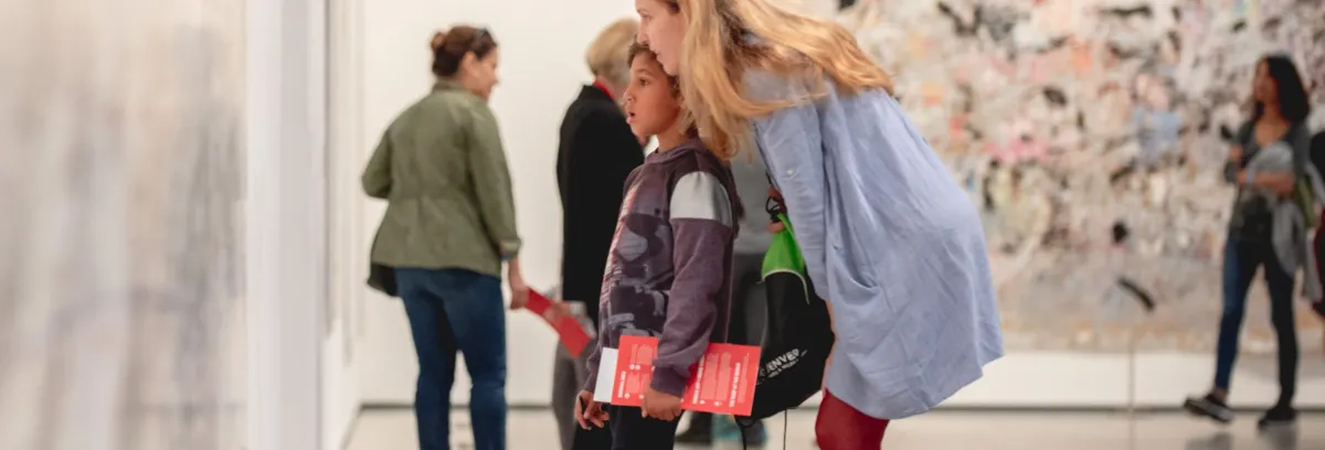 Photo of a woman and a boy looking at a painting at The Broad together