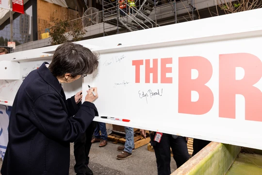 Lead architect Elizabeth Diller signing the steel beam at the topping out ceremony