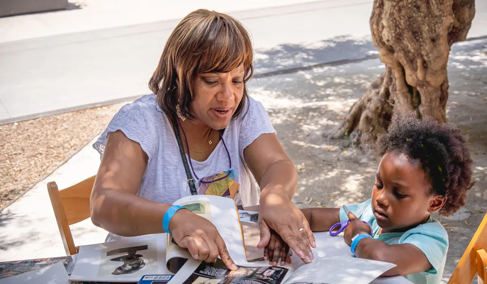 caregiver and child participating in an art-making activity