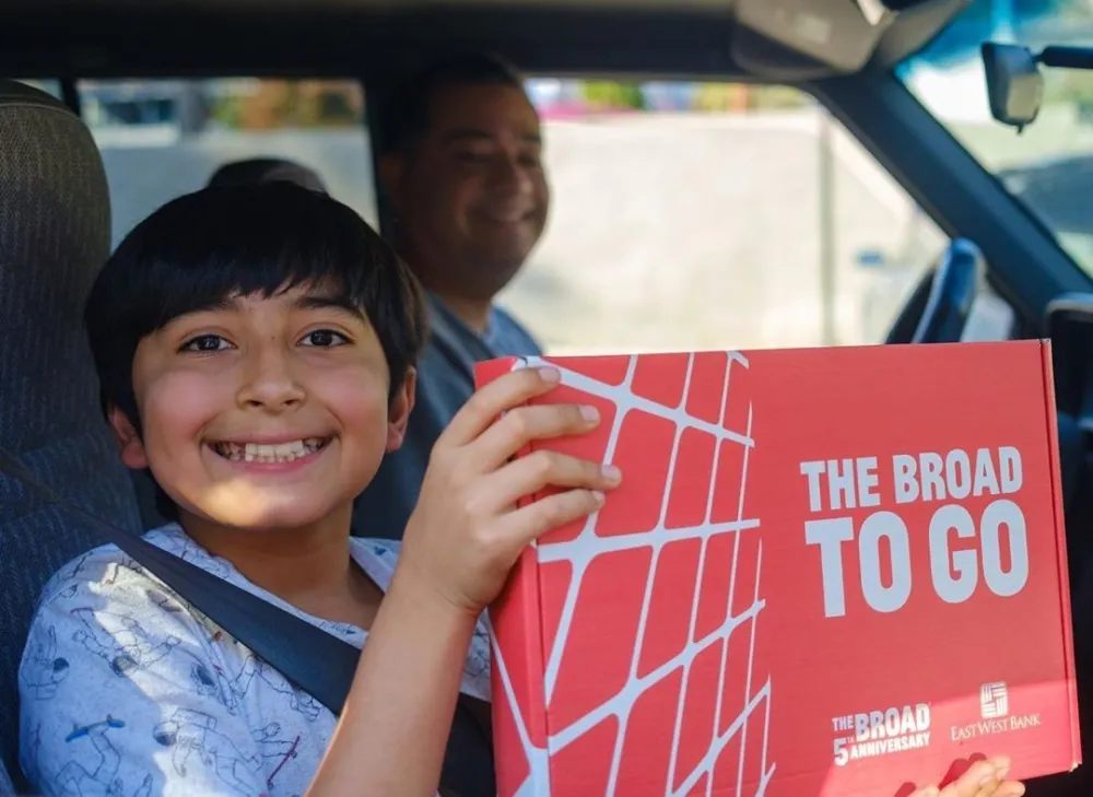 Photo of child in car picking up The Broad To Go art kit