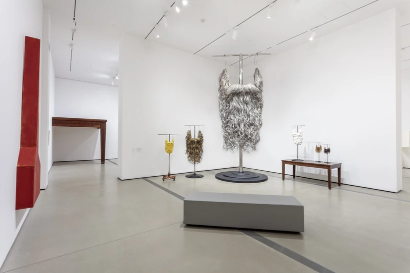 Installation image inside Robert Therrien: This is a Story, featuring a series of beard sculptures in different sizes