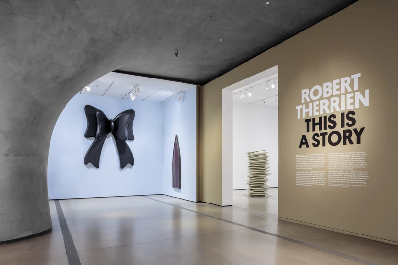 Installation image inside Robert Therrien: This is a Story, featuring the entrance of the exhibition and an oversized bow sculpture