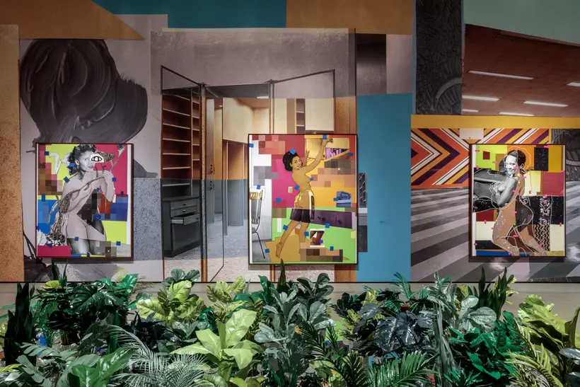 Gallery shot of Mickalene Thomas All About Love Exhibition featuring a room with three collaged painting with plants in the foreground