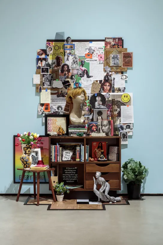 Photo of the Mickalene Thomas's altar featuring miscellaneous objects books and photos