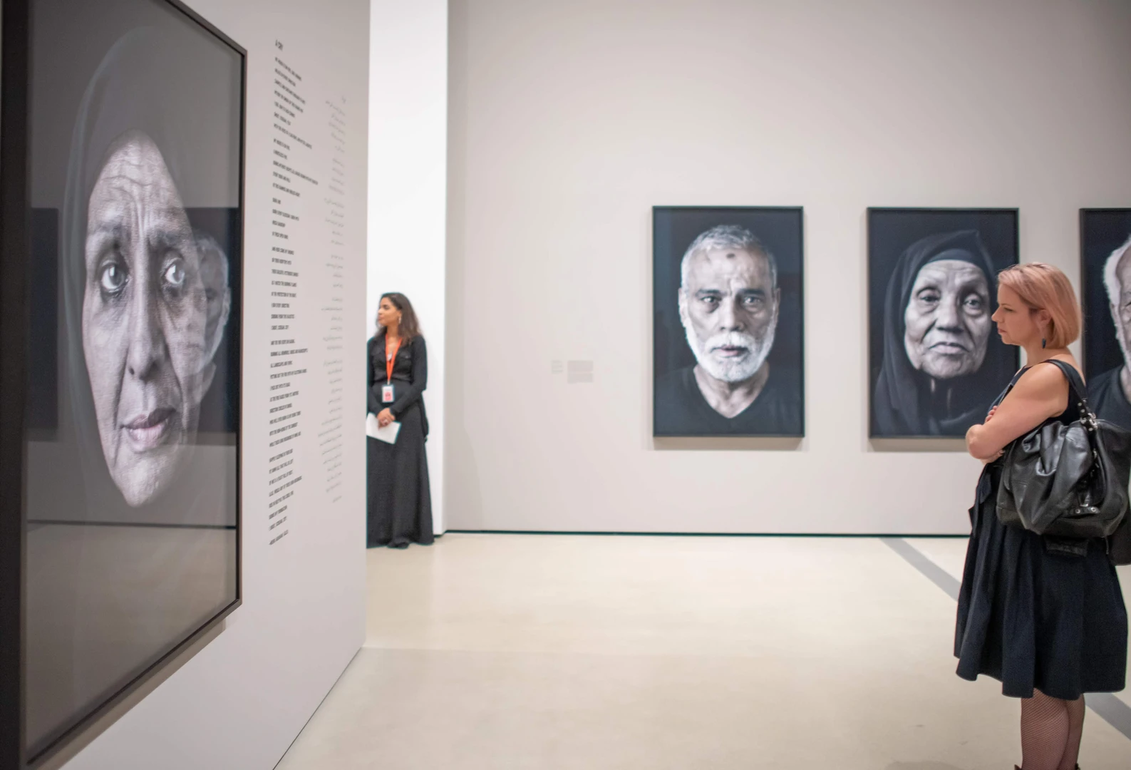 Photo of visitor looking at Shirin Neshat's work.