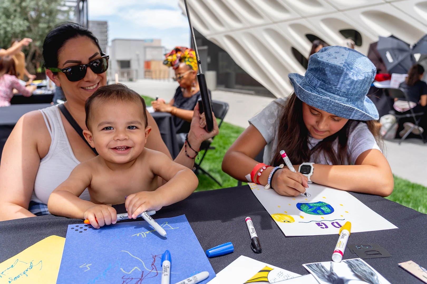 family making art at a table