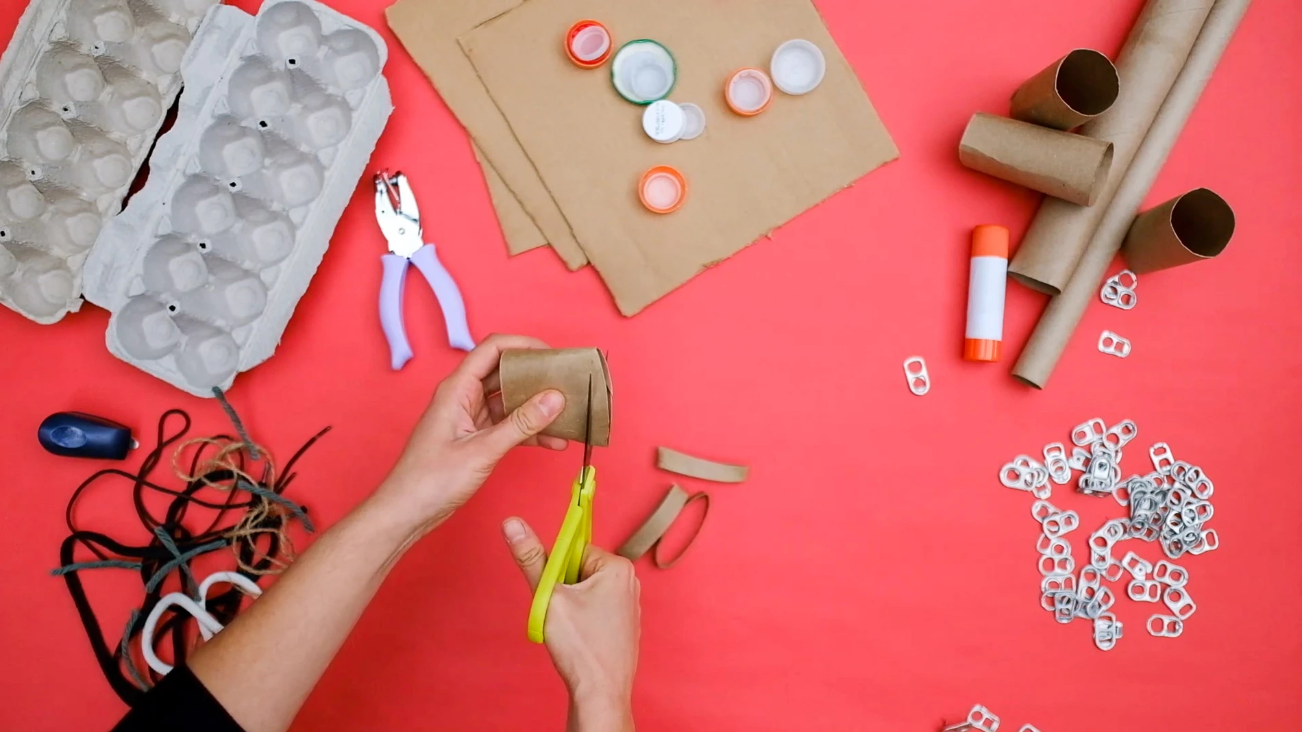 still of woman's hands making an art activity from the El Anatsui-inspired family art workshop