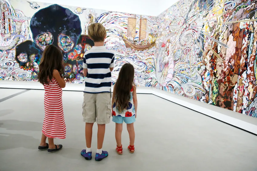 A family looks at a Takashi Murakami's painting "In the Land of the Dead, Stepping on the Tail of a Rainbow"