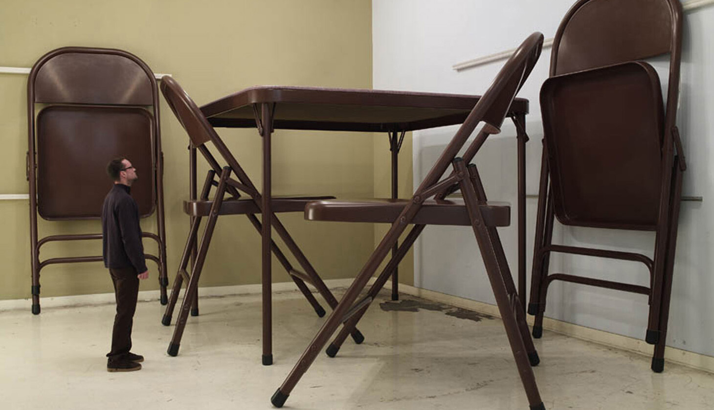 oversized brown folding table with a person next to it for size